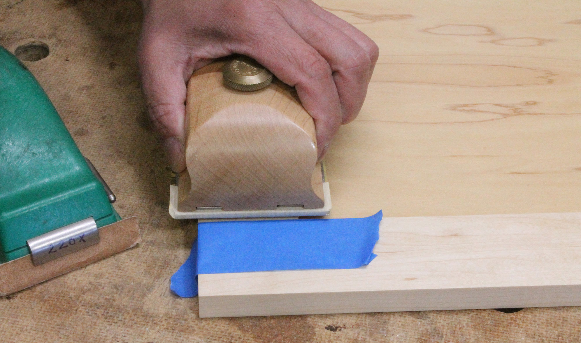 Using tape to prevent sanding scratches.