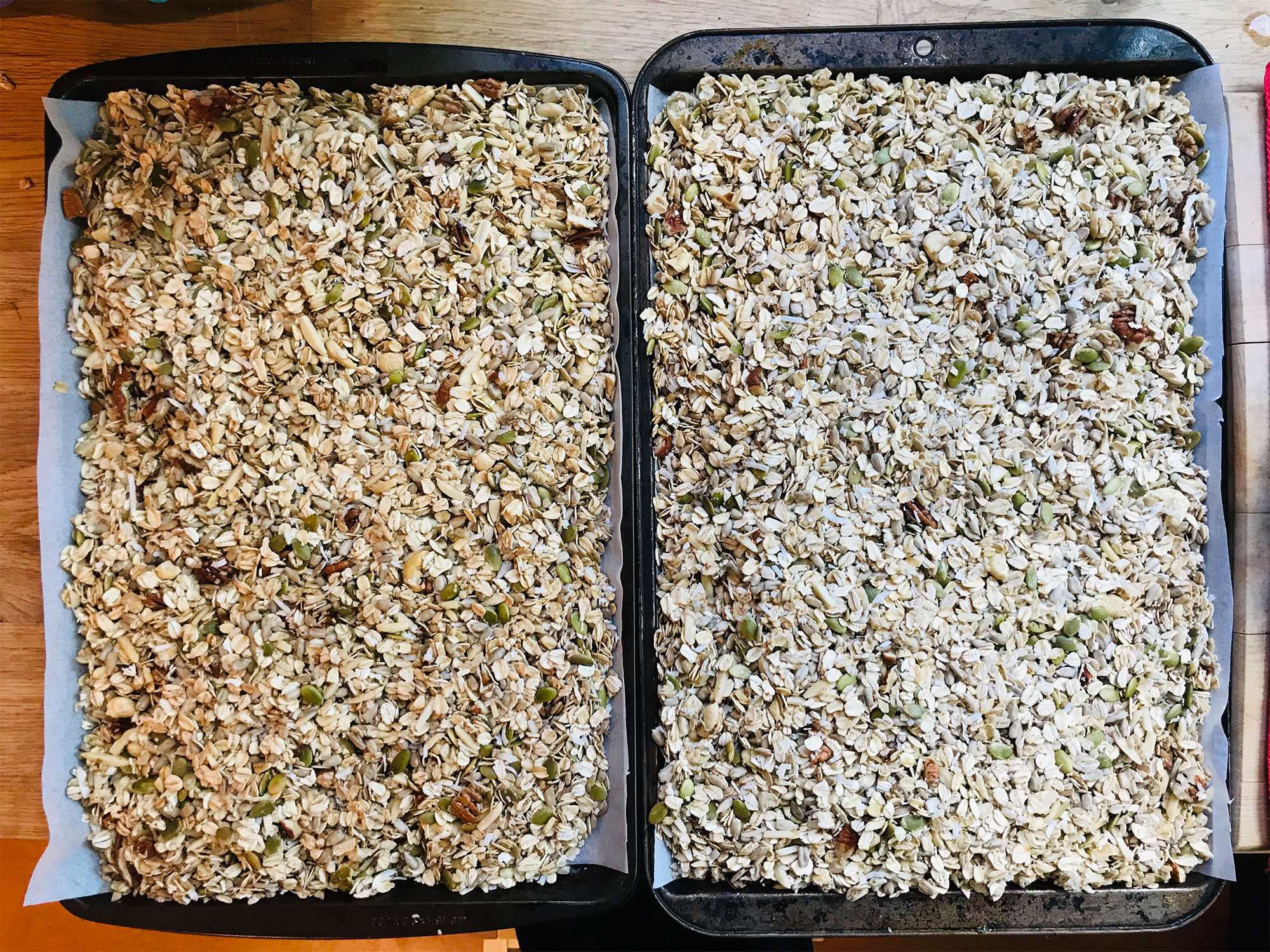 Granola spread on sheet pans ready for the oven