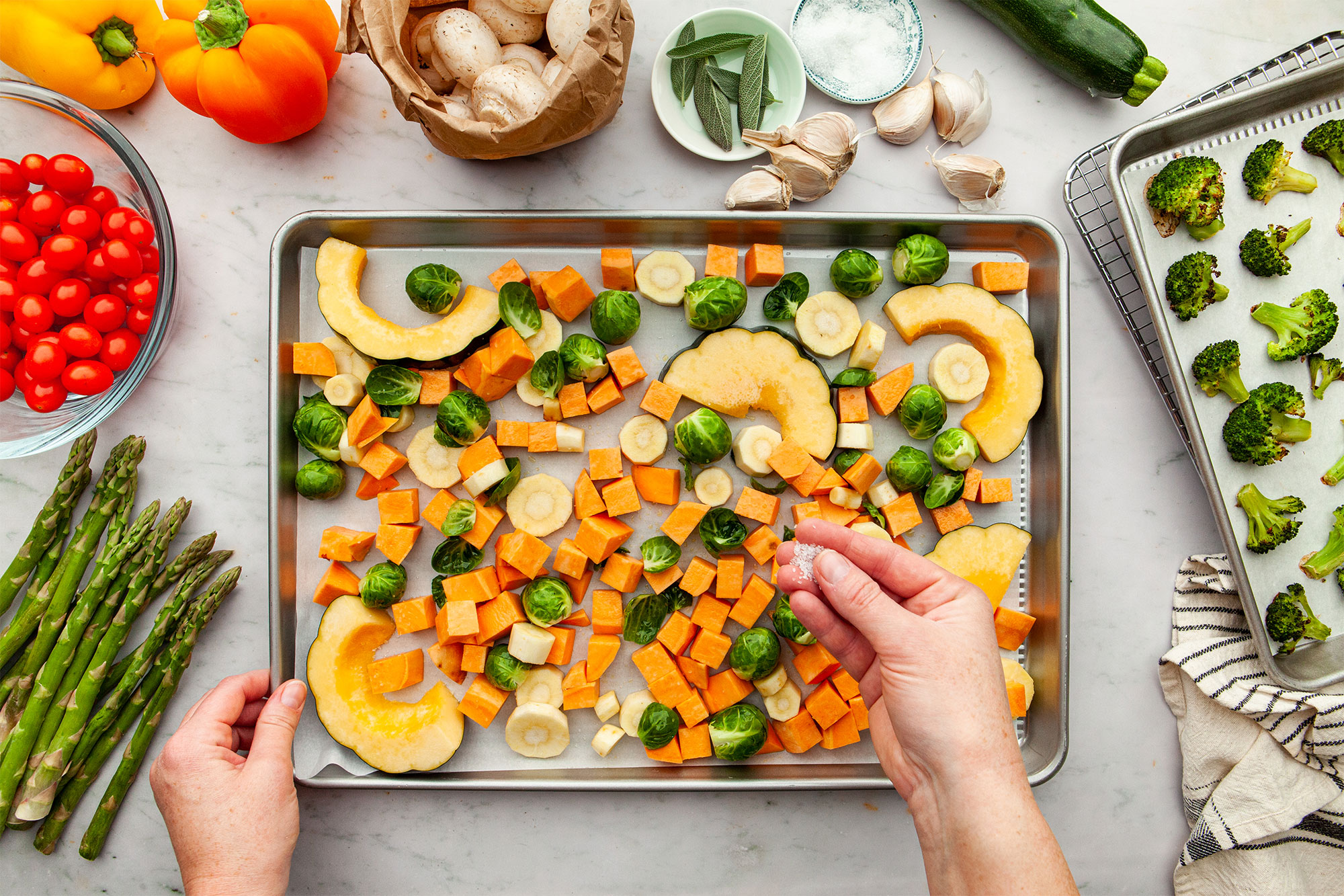 Laying the harder vegetables on the sheet pan as the first layer.