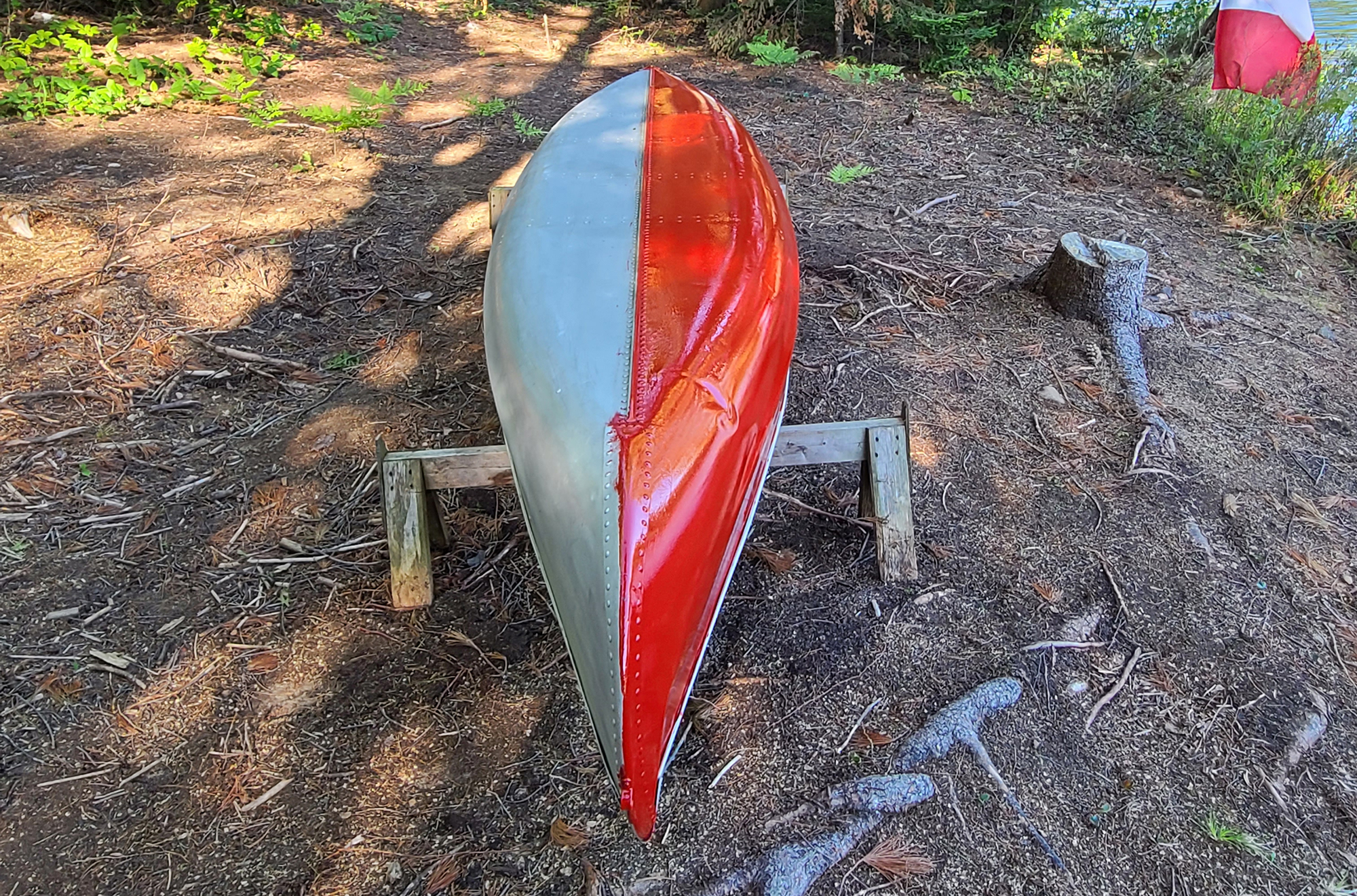 One half of canoe (right side) painted red.