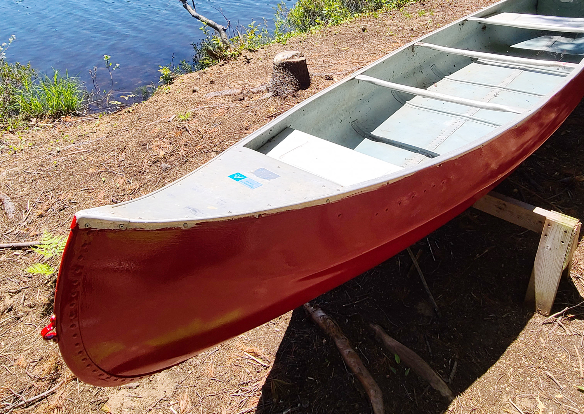 Newly painted canoe drying in sun.