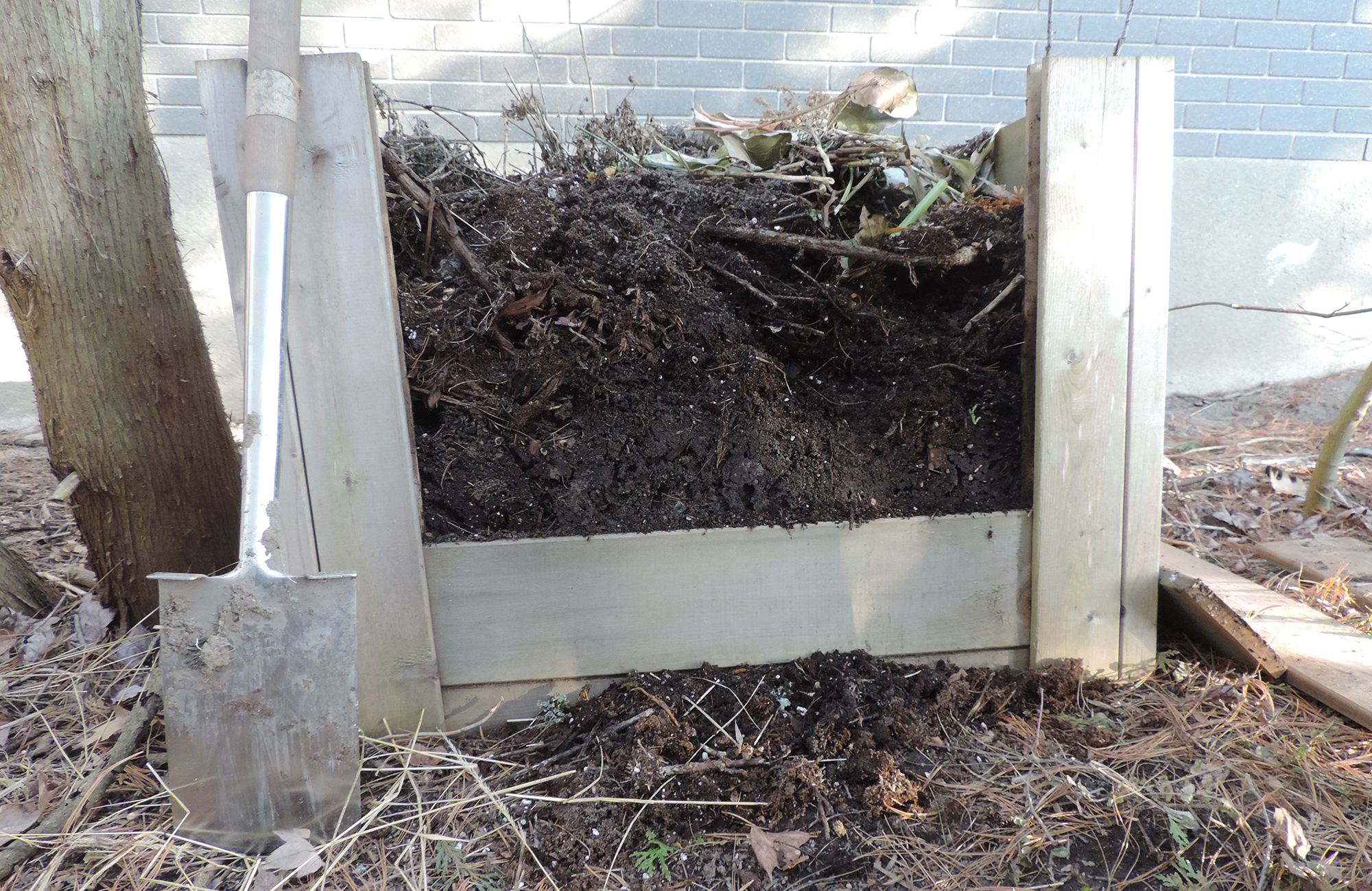 Compost pile in open wooden box.