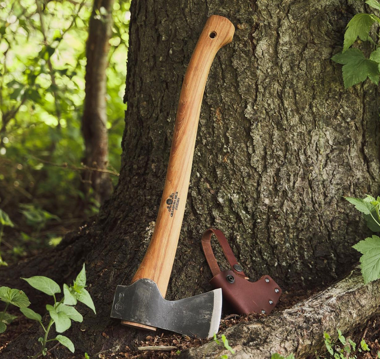 A Gransfors small forest axe leaning against a tree.