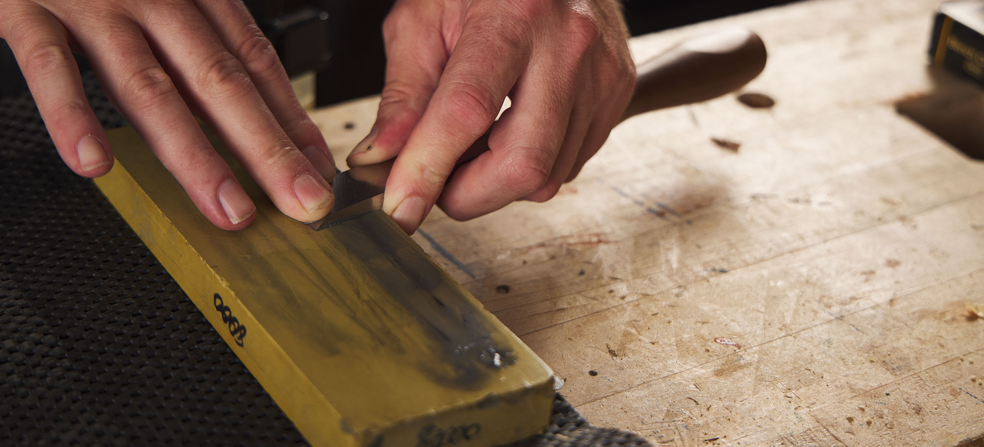 Polishing the chisel back on a sharpening stone