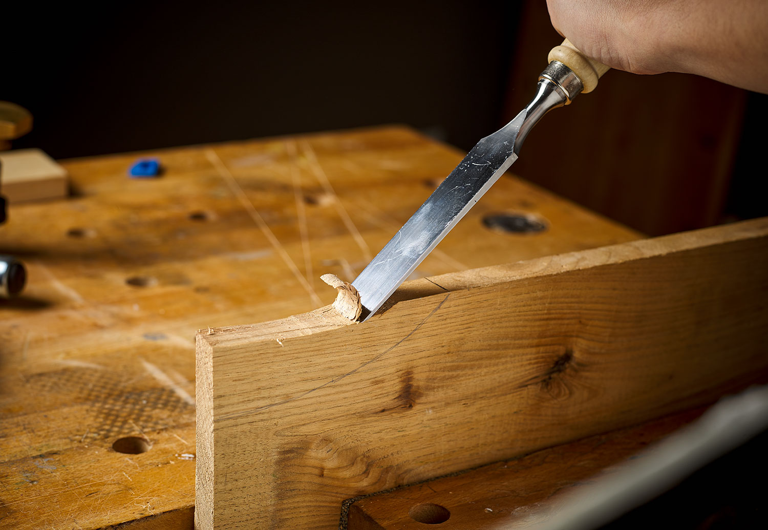 Cutting a concave surface with a chisel and mallet.