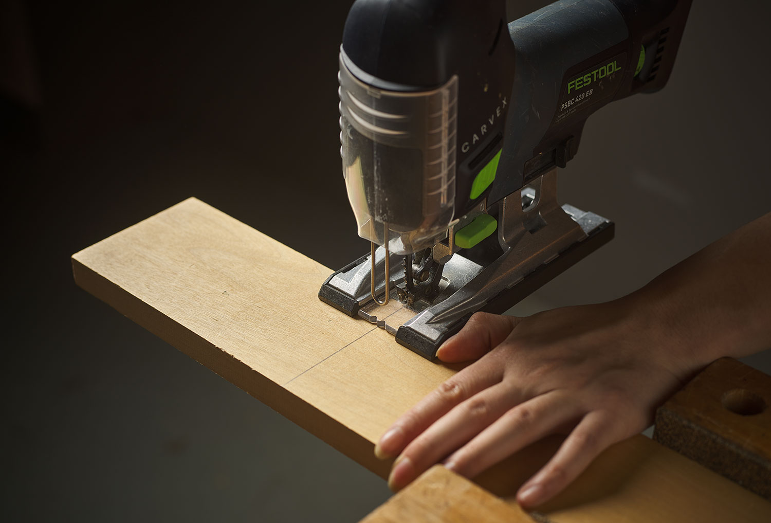 Using a thumb to guide the base plate of the saw