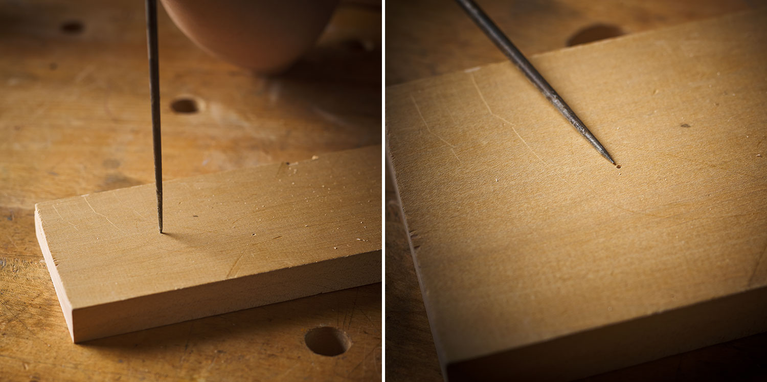 Using an awl to mark the center point for accurate drill bit placement