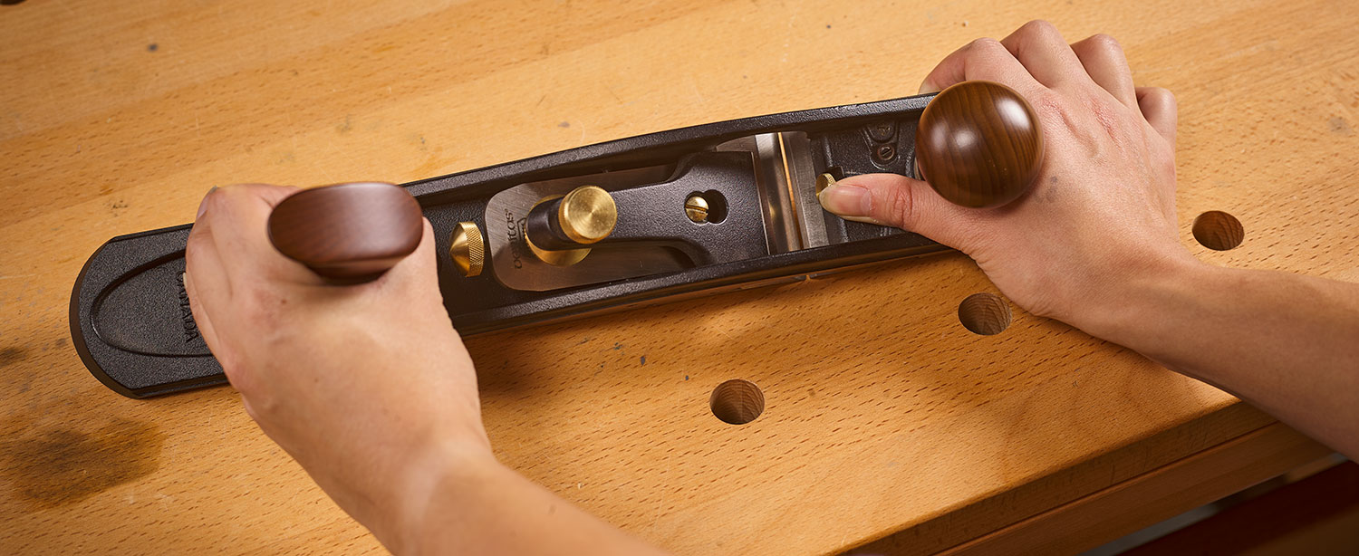 Using the mouth adjustment screw to set the opening.