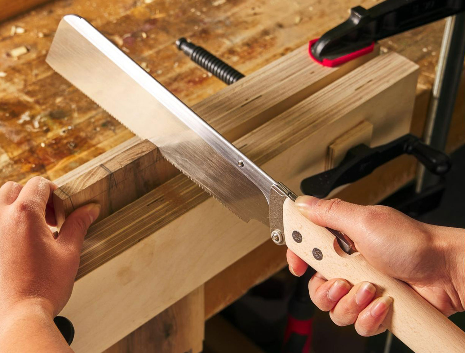 Cutting a dovetail joint using a folding dozuki saw.