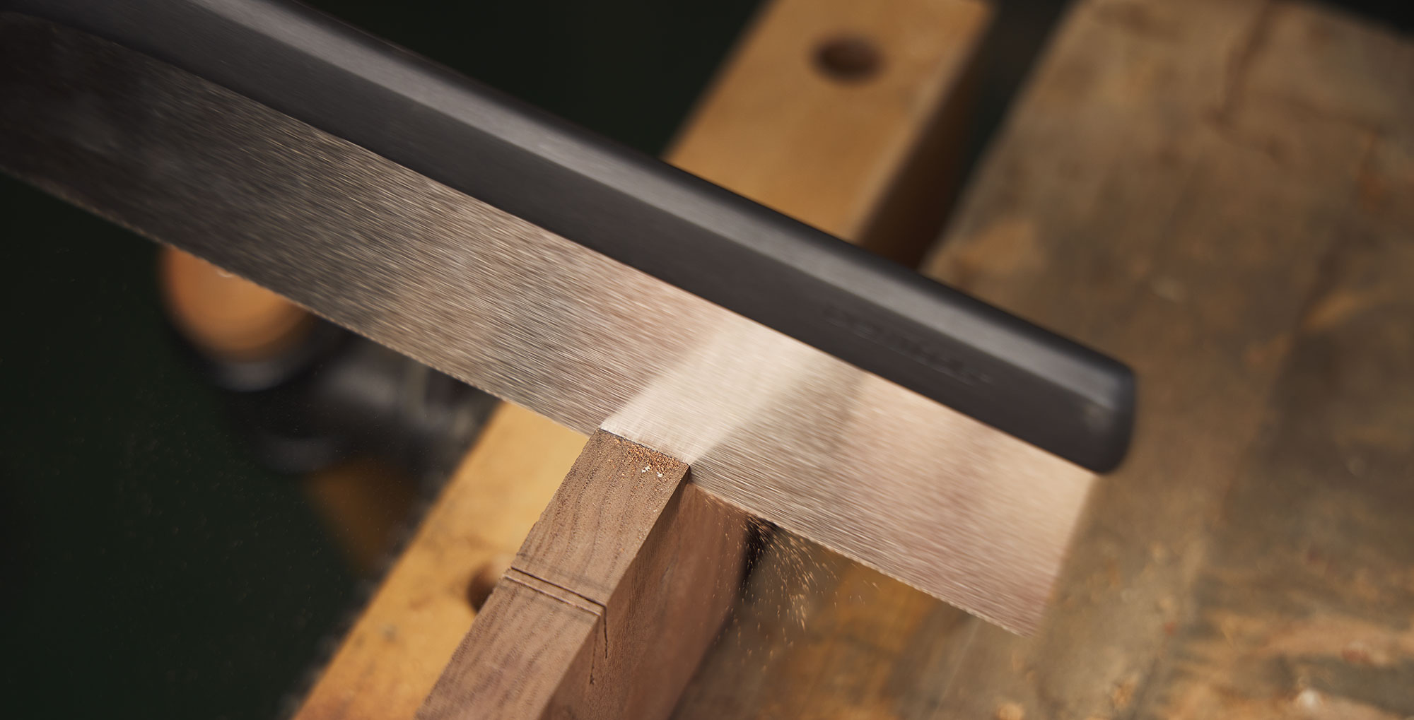 Close-up of saw blade cutting a dovetail joint