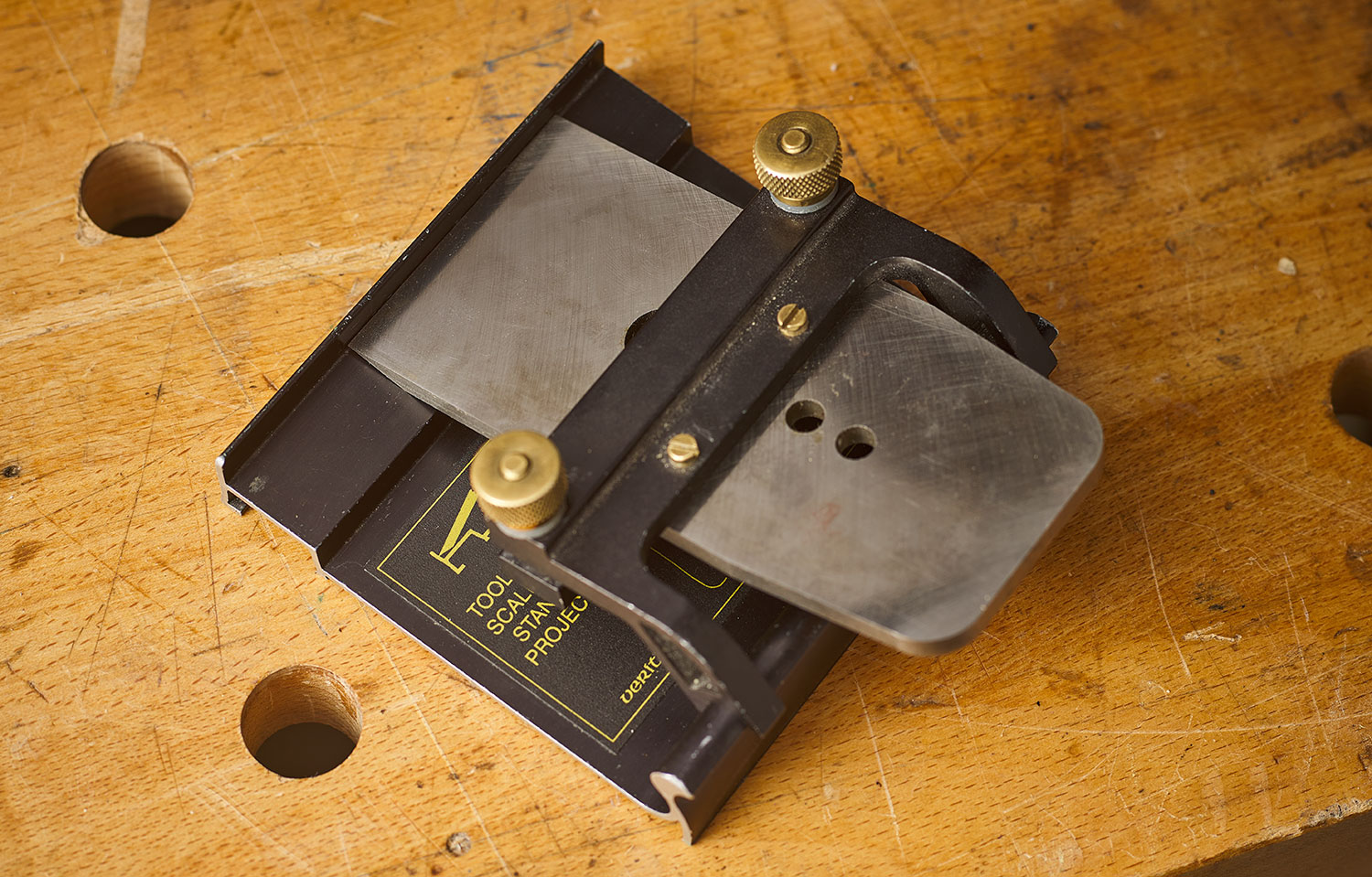 A plane blade held in the Mk.II power sharpening blade holder and placed on the blade-setting jig.
