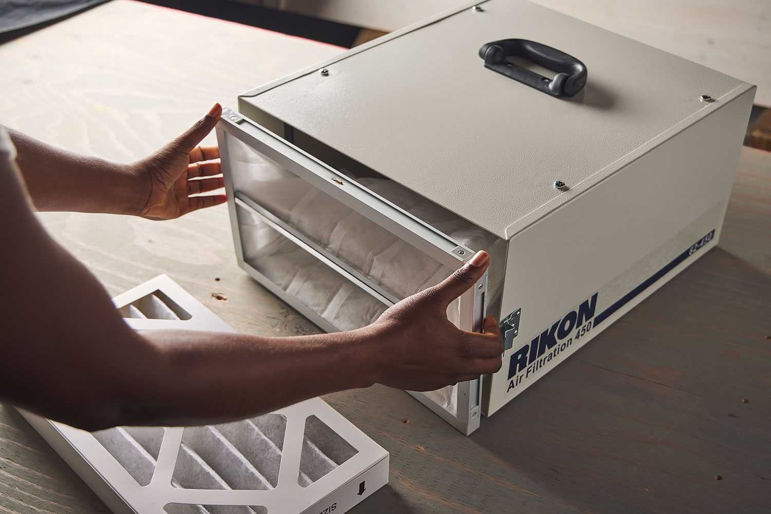 Opening a Rikon model 62-450 air cleaner for access to the inner pleated filter.