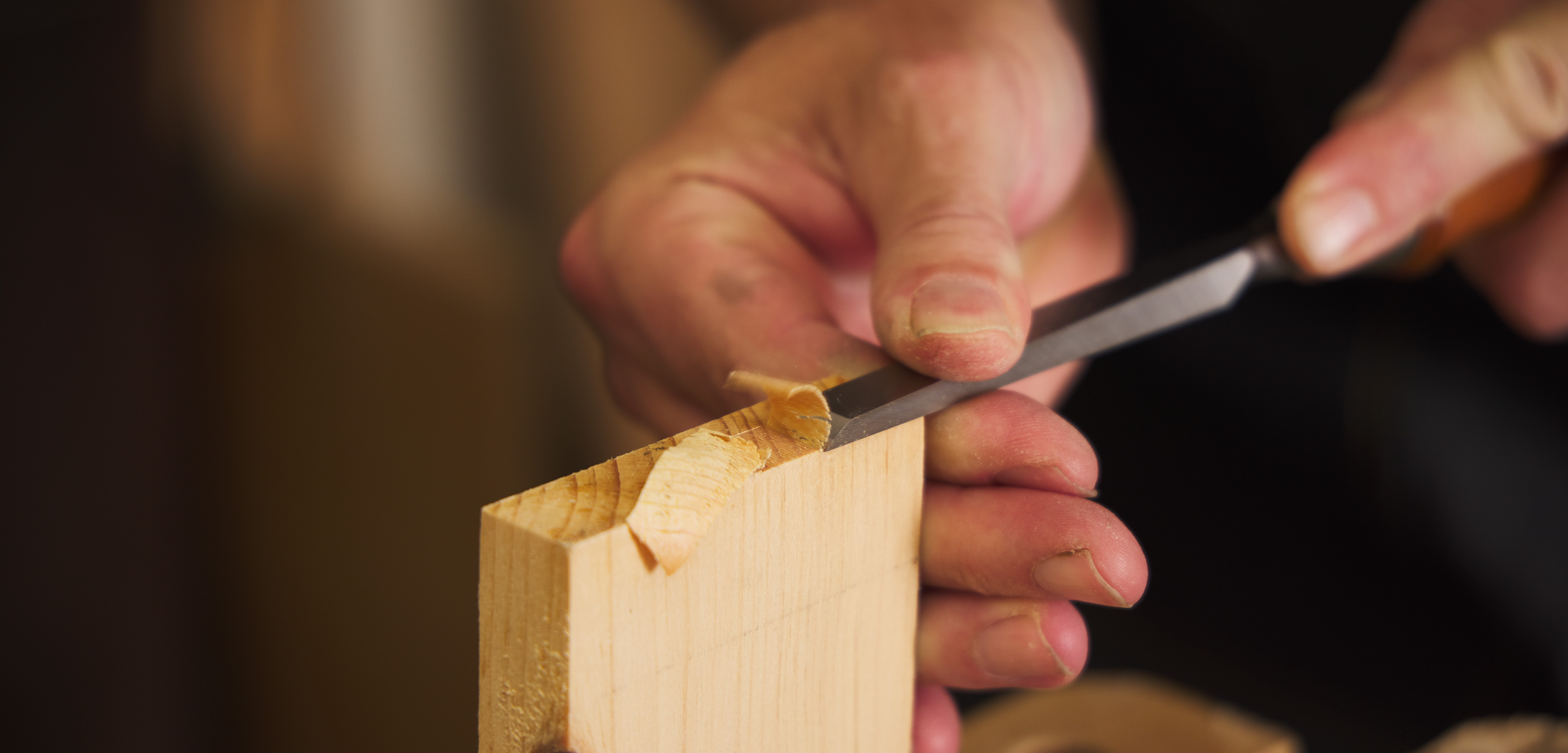 Testing the edge of a chisel sharpened on a T-8 sharpening machine by cutting across end grain.