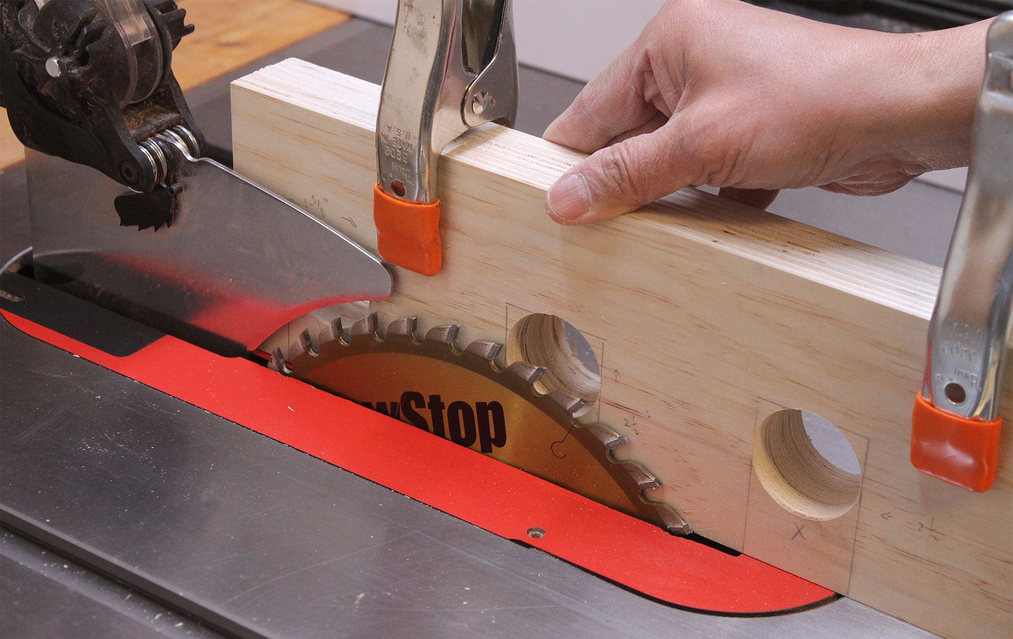 Setting blade height using the rack stood on its edge on the table saw.