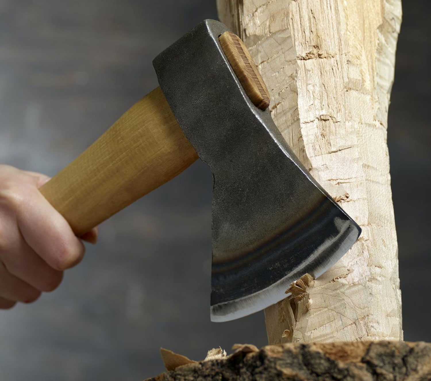 Using a carving axe to rough out a wooden blank.