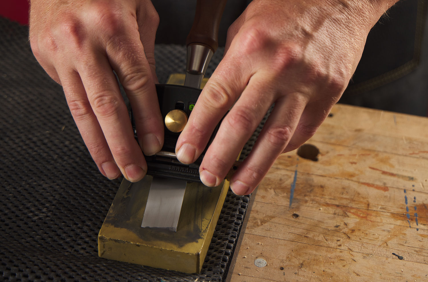 A chisel being sharpened on a Japanese water stone.