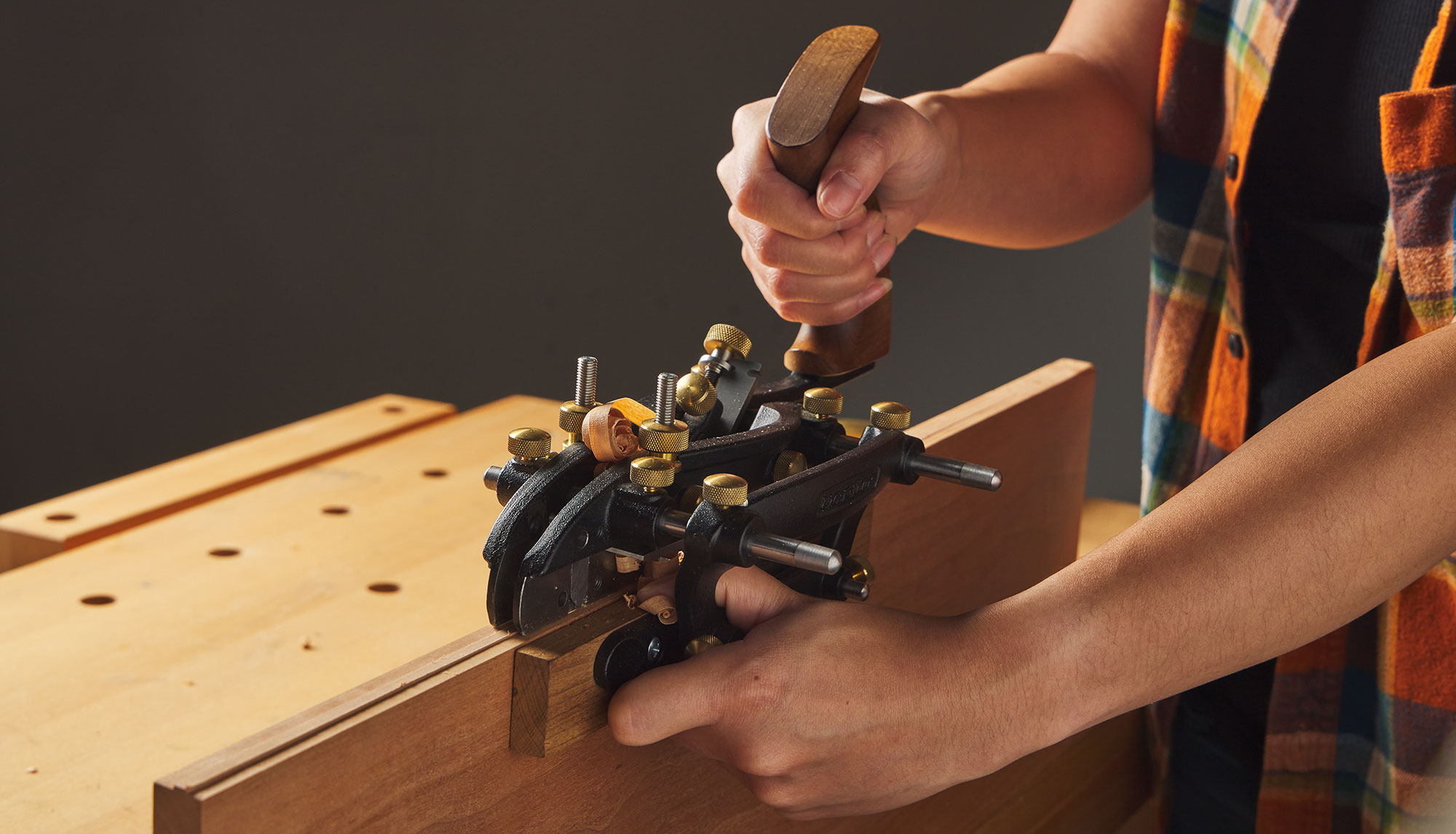Cutting a tongue with the combination plane.