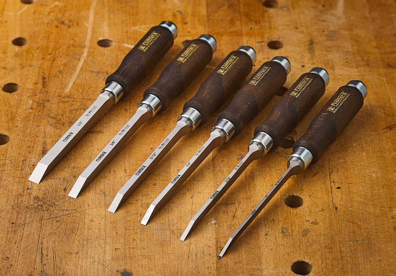 Five Narex mortise chisels lined up on a workbench.